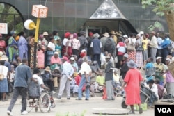 FILE - Pensioners gather outside a bank in Harare, Zimbabwe, March 14, 2016. (S. Mhofu)