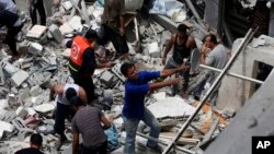 Warga Palestina mencari korban di antara reruntuhan rumah keluarga al-Bakri di Gaza yang hancur akibat serangan udara Israel, Senin (4/8).