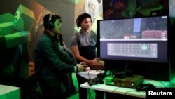 FILE - Gamers play Minecraft at the Paris Games Week (PGW), a trade fair for video games in Paris, France.