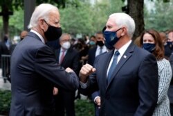 Democratic presidential candidate Joe Biden greets Vice President Mike Pence at the 19th anniversary ceremony in observance of the Sept. 11 terrorist attacks at the National September 11 Memorial & Museum in New York, Sept. 11, 2020.