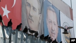 Posters of Mustafa Kemal Ataturk (L) founder of modern Turkey, and current President Recep Tayyip Erdogan are displayed at the Spice Bazaar plaza, during the re-opening ceremony following its restoration in Istanbul, May 4, 2018. 