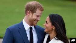 Prince Harry and Meghan Markle pose during an official photocall to announce thier engagement at The Sunken Gardens at Kensington Palace on Nov. 27, 2017 in London, England. 