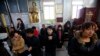 FILE - Believers take part in a weekend mass at an underground Catholic church in Tianjin.