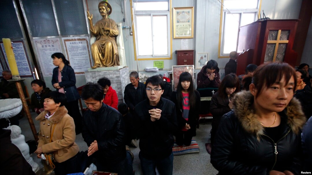 Believers take part in a weekend mass at an underground Catholic church in Tianjin, November 10, 2013. 
