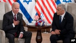 President Joe Biden, left, and Israeli Prime Minister Yair Lapid address the media following their meeting in Jerusalem, July 14, 2022.