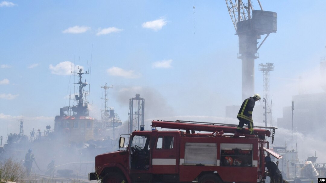 Petugas pemadam kebakaran Ukraina berusaha memadamkan api pada kapal yang terbakar di pelabuhan Odesa, Ukraina, setelah serangan misil menghantam area pelabuhan pada 23 Juli 2022. (Foto: Odessa City Council/AFP)