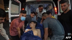 An injured youth is loaded into an ambulance following Turkish shelling in the city of Zakho in the north of Iraq's autonomous Kurdish region on July 20, 2022.