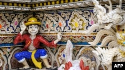 FILE - This July 14, 2020, photo shows the 'One Piece' manga character Monkey D. Luffy among imaginary creatures on the facade of the Wat Pariwat Buddhist temple in Bangkok.