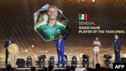 FILE: Senegalese forward Sadio Mane (L) speaks after winning the Men's Player of the Year, in the presence of CAF President Patrice Motsepe (2nd-L), during the 2022 Confederation of African Football (CAF) Awards on 7.21.2022 in the Moroccan capital Rabat. 