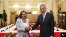 In this photo provided by Ministry of Communications and Information, Singapore, U.S. House Speaker Nancy Pelosi, left, and Prime Minister Lee Hsien Loong shake hands at the Istana Presidential Palace in Singapore, Monday, Aug. 1, 2022. (Ministry of Commu