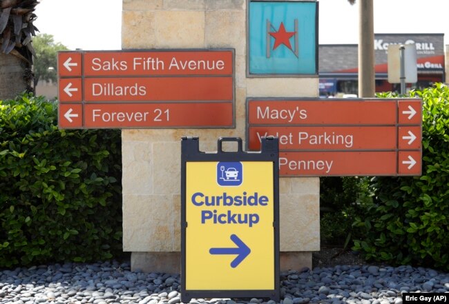 A sign directs shoppers to curbside pickup at North Star Mall in San Antonio, Texas, April 24, 2020. (AP Photo/Eric Gay)