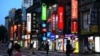 People walk on the streets during sunset hours in Taipei, Taiwan, June 27, 2022. 