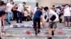 FILE - Plainclothes security personnel drag a demonstrator down stairs during a protest over the freezing of deposits by some rural-based banks, outside a People's Bank of China building in Zhengzhou, China, July 10, 2022, in a video screengrab obtained by Reuters.