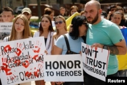 A woman reacts during a rally of relatives of defenders of the Azovstal Iron and Steel Works in Mariupol demanding to recognise Russia as a state sponsor of terrorism after killing Ukrainian prisoners of war (POWs) in a prison in Olenivka, outside of Done