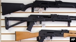 FILE - Semiautomatic rifles are displayed on a wall at a gun shop in Lynnwood, Wash., Oct. 2, 2018. The U.S. House on July 29, 2022, passed legislation that would revive a ban on such weapons. 