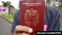 A Venezuelan migrant shows his passport in Costa Rica.  Photo Houston Castillo, VOA