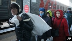 People from Mariupol and eastern Ukraine disembark from a train at the railway station in Nizhny Novgorod, Russia, Thursday, April 7, 2022, to be taken to temporary residences in the region. (AP Photo)