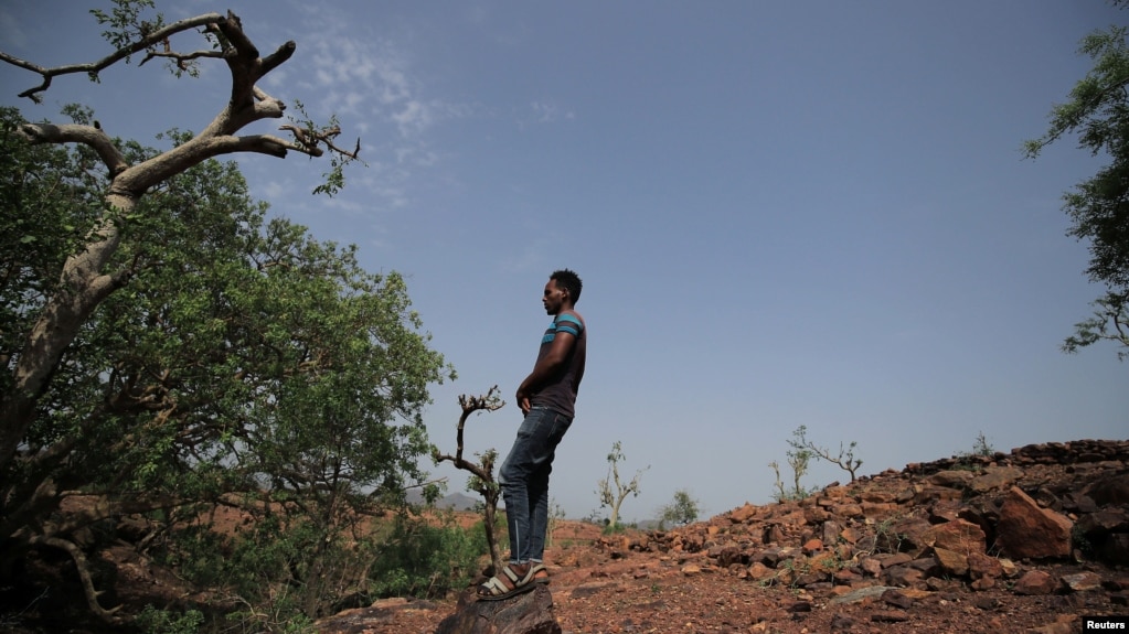 FILE - An Eritrean refugee stands on a hill after a Reuters interview outside of Mai Aini Refugee camp near Mai Tsberi town in Tigray Region, Ethiopia, June 26, 2021. 