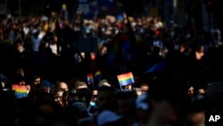 FILE - People march during a gay pride parade in Budapest, Hungary, July 24, 2021. The European Union's executive intensified its legal standoff with Hungary on July 15, 2022, by taking the country to the EU's highest court over a law on LGBT issues and media rules.