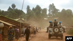 
Des soldats de la mission de l'ONU en RDC (Monusco) roulent à bord d'un véhicule alors qu'ils patrouillent dans le territoire de Djugu, province de l'Ituri, à l'est de la RDCongo, le 13 mars 2020. (Photo SAMIR TOUNSI / AFP)