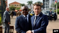 FILE - French President Emmanuel Macron (R) meets with Guinee Bissau's President Umaro Sissoco Embalo upon his arrival at the presidential palace in Bissau on July 28, 2022.