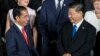 FILE - Indonesia's President Joko Widodo, left, speaks to China's President Xi Jinping at the G-20 summit, on June 28, 2019, in Osaka, Japan. Widodo was heading to Beijing on July 25, 2022, for a rare visit by a foreign leader under China's strict COVID-19 protocols.