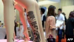 FILE - 'Tattoo stockings' featuring Japanese manga character One Piece are displayed at the Tokyo International gift show Sept. 4, 2013.