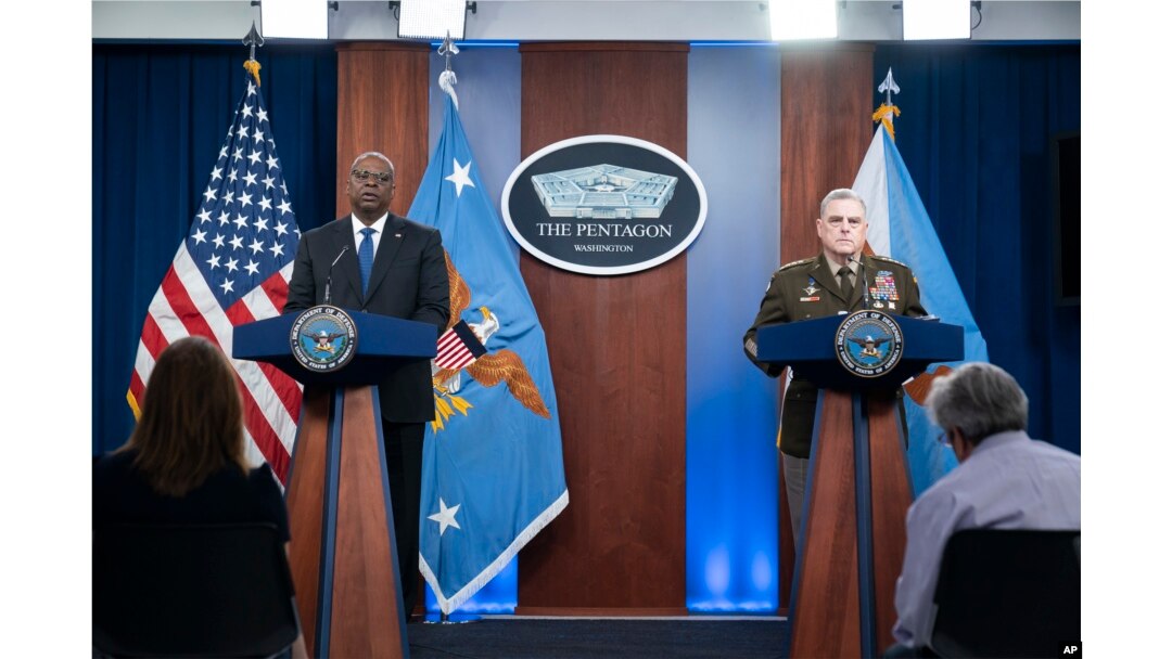 Secretary of Defense Lloyd Austin, left, and Joint Chiefs Chairman Gen. Mark Milley speak during a media briefing at the Pentagon, July 20, 2022, in Washington. American defense leaders said they see the war to block Russian gains in the eastern Donbas re