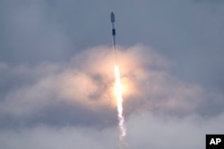 FILE - A SpaceX Falcon 9 rocket, with a payload of Starlink satellites for a high-speed debased  world  orbit net  constellation, lifts disconnected  from motorboat  analyzable  40 astatine  Cape Canaveral Space Force Station successful  Cape Canaveral, Florida, July 17, 2022.