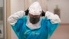 Micro-biologist Annette Atkinson adjusts her respirator during a demonstration how the monkeypox is tested for in Taylorsville, Utah, on July 29, 2022. The World Health Organization has declared the viral infection a global public health emergency.