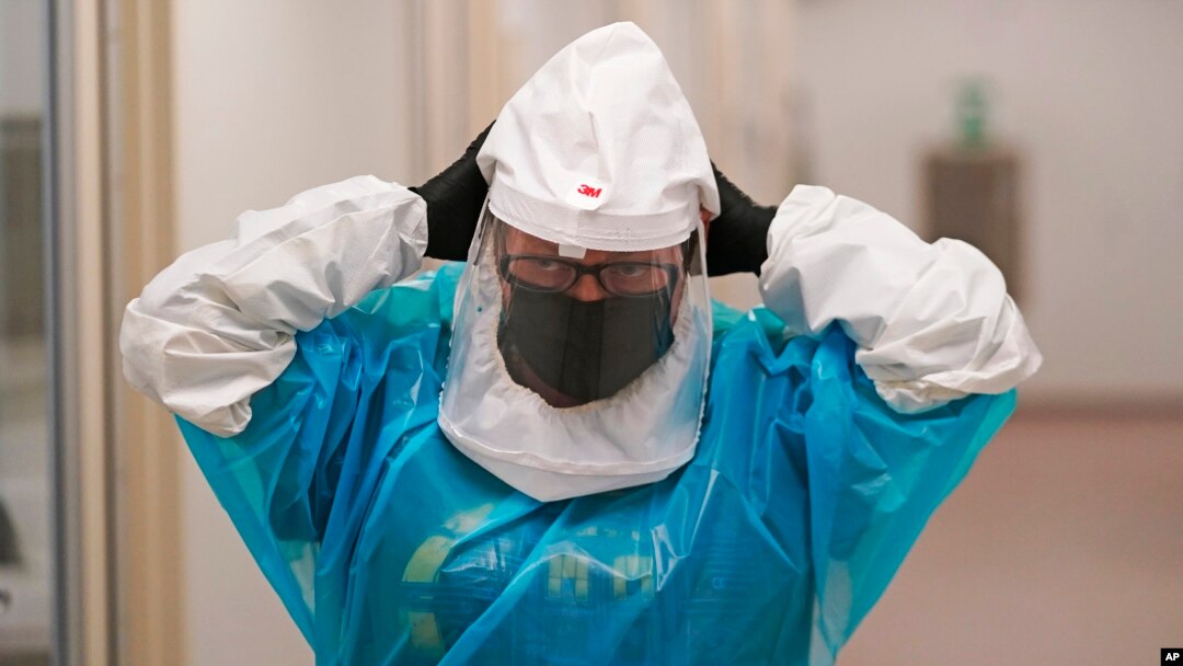 Micro-biologist Annette Atkinson adjusts her respirator during a demonstration how the monkeypox is tested for in Taylorsville, Utah, on July 29, 2022. The World Health Organization has declared the viral infection a global public health emergency.