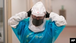 Micro-biologist Annette Atkinson adjusts her respirator during a demonstration how the monkeypox is tested for in Taylorsville, Utah, on July 29, 2022. The World Health Organization has declared the viral infection a global public health emergency.