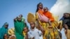 FILE - Somalis who fled drought-stricken areas carry their belongings as they arrive at a makeshift camp for the displaced on the outskirts of Mogadishu, Somalia, on June 30, 2022. 