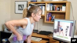 Woman exercises at home using an online class. (AP File Photo)
