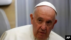 Pope Francis speaks to journalists aboard the papal flight back from Canada, July 30, 2022.