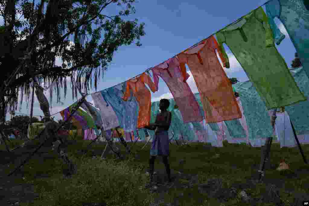 A dhobi or a washerman hangs cloths for drying on the banks of the River Gomti in Lucknow, northern Uttar Pradesh state, India.