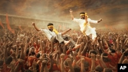This image released by Netflix shows Ram Charan and N.T. Rama Rao Jr. in a scene from "RRR." (Netflix via AP)