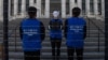 FILE - Activists set up a mock Uyghur forced labor camp during a protest in Washington, D.C., March 4, 2022.