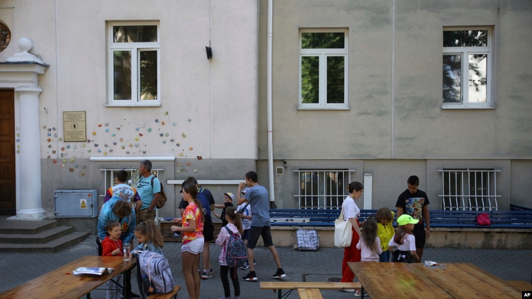 Ukrainian refugee children gather outside the Lauder Morasha Jewish school in Warsaw, Poland, July 28, 2022.