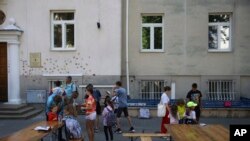 Ukrainian refugee children gather outside the Lauder Morasha Jewish school in Warsaw, Poland, July 28, 2022.
