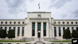 FILE - An American flag flies over the Federal Reserve building in Washington, May 4, 2021. A report issued July 26, 2022, by Senate Republicans alleges that China is trying to infiltrate the Federal Reserve. 