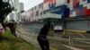 Protesters tear down a barrier at the headquarters of the Partido Revolucionario Democratico during a protest against the high cost of food and gasoline in Panama City, July 20, 2022.