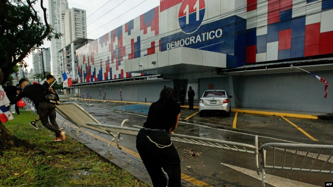 Protesters tear down a barrier at the headquarters of the Partido Revolucionario Democratico during a protest against the high cost of food and gasoline in Panama City, July 20, 2022.