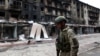 A Ukrainian serviceman passes destroyed buildings in the Ukrainian town of Siversk, Donetsk region, on July 22, 2022, amid the Russian invasion of Ukraine.