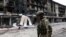 A Ukrainian serviceman passes destroyed buildings in the Ukrainian town of Siversk, Donetsk region, on July 22, 2022, amid the Russian invasion of Ukraine.