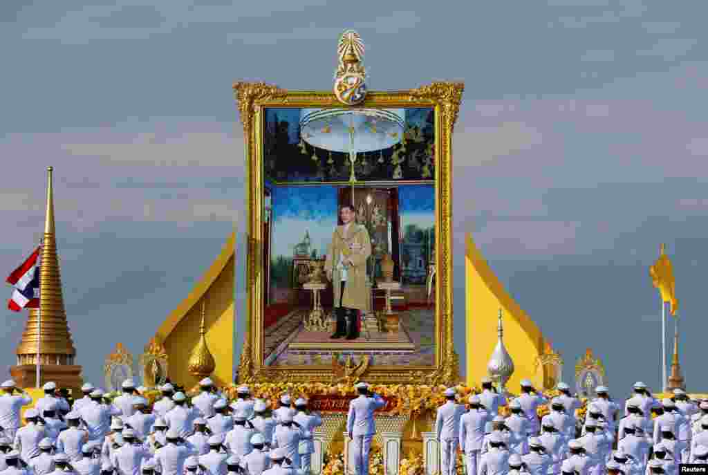 Thailand's Prime Minister Prayuth Chan-ocha and cabinet members pay respect to a picture of Thai King Maha Vajiralongkorn during a celebration to mark the king's 70th birthday in Bangkok, Thailand.