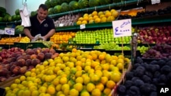 A worker rearranges fruits on display for sale at a shop in Beirut, Lebanon, July 15, 2022.