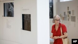 FILE - Micheline Tinader, 91, visits an exhibition at the Shoah memorial, July 12, 2022 in Drancy, outside Paris. Tinader was a hidden Jew child during WW2.