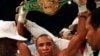 FILE: Sugar Ray Leonard, U.S.A., holds the middleweight championship belt above his head after defeating Marvin Hagler in a split decision to win the title in Las Vegas, Nev., April 6, 1987.