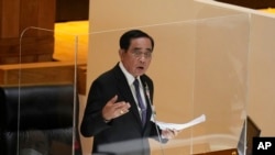 Thailand Prime Minister Prayuth Chan-ocha answers questions during a no-confidence debate at the Parliament in Bangkok, Thailand, Tuesday, July 19, 2022. 